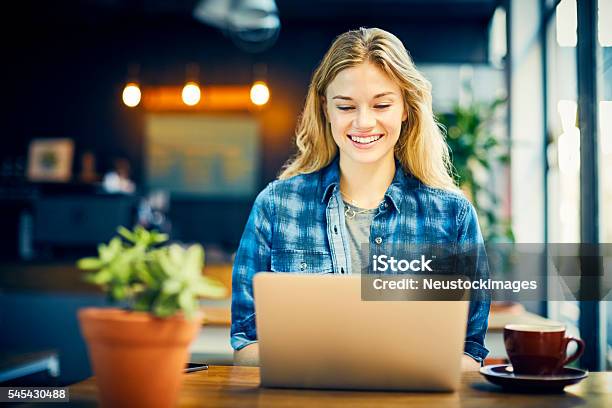 Smiling Trendy Woman Using Laptop In Cafe Stock Photo - Download Image Now - Coffee Shop, Only Women, Women