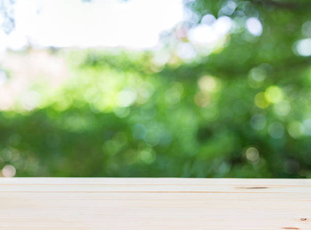 istock Wood table top on green bokeh abackground. 545430662