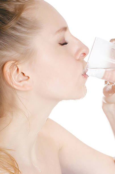 istock young woman drinking water, on white background 545430866