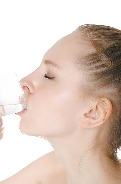 istock young woman drinking water, on white background 545430934