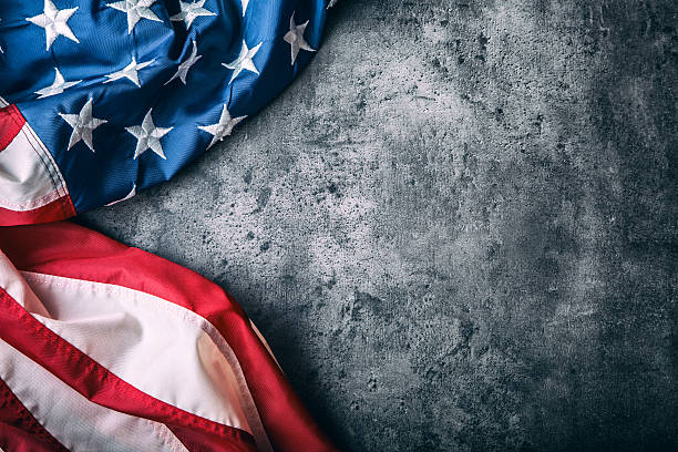 istock USA flag. American flag freely lying on concrete background. 545431050