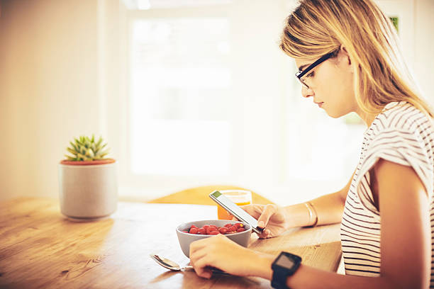 istock Female hipster with smart phone and breakfast 545431180