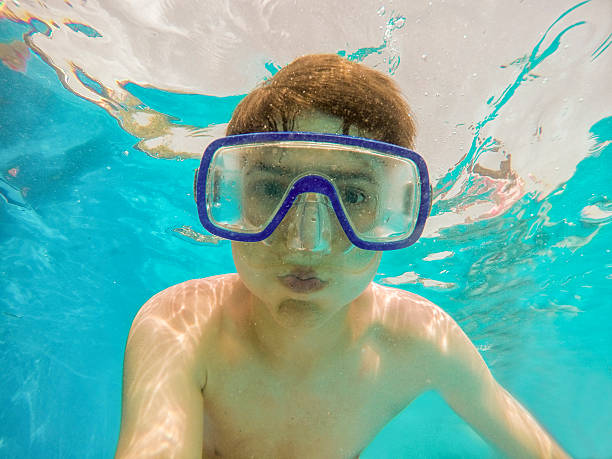 istock teenager diving into a pool 545431508