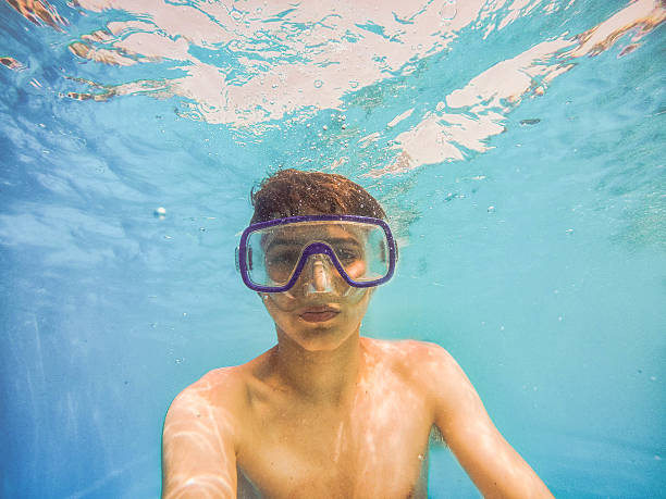 istock teenager diving into a pool 545431600