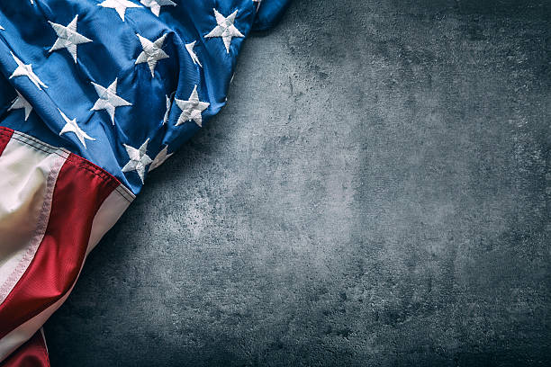 istock USA flag. American flag freely lying on concrete background. 545432152