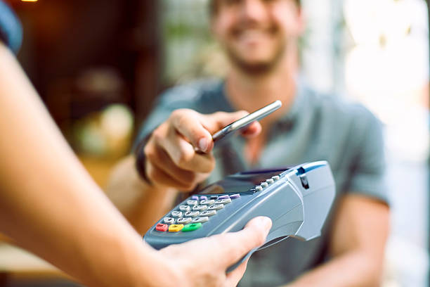 istock Male customer making mobile payment at cafe 545433258