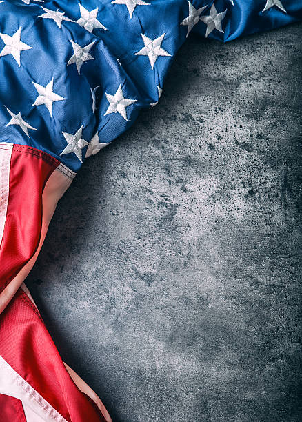 istock USA flag. American flag freely lying on concrete background. 545433342