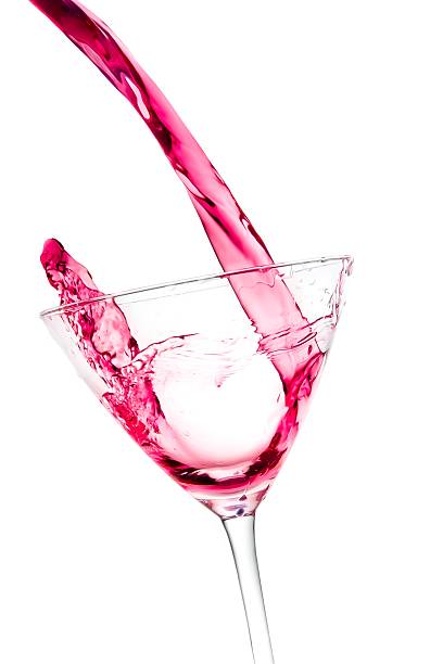 istock pouring a glass with red cocktail tilted and splashing 545433784