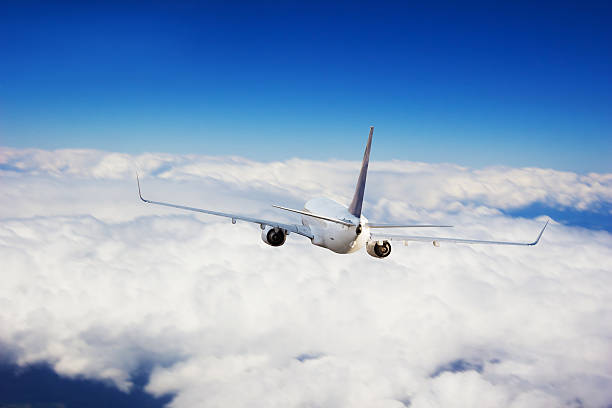 istock Commercial jet plane flying above clouds 545433836