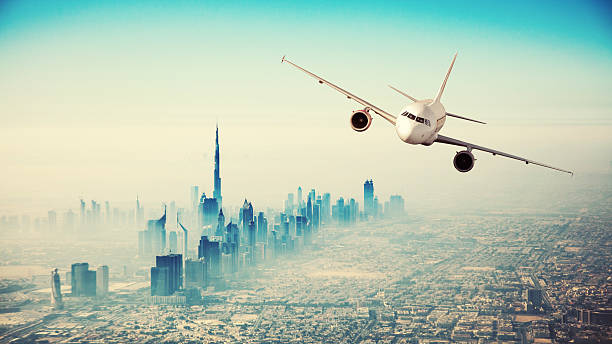 istock Commercial airplane flying over modern city 545433910