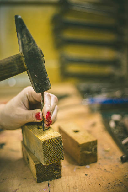 istock Young woman hammering in workshop, busy. 545434128