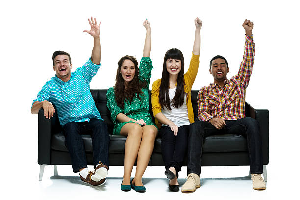 istock Four friends on couch and cheering 545435444