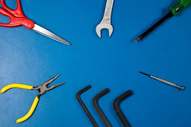Photo of Tools on blue table background.