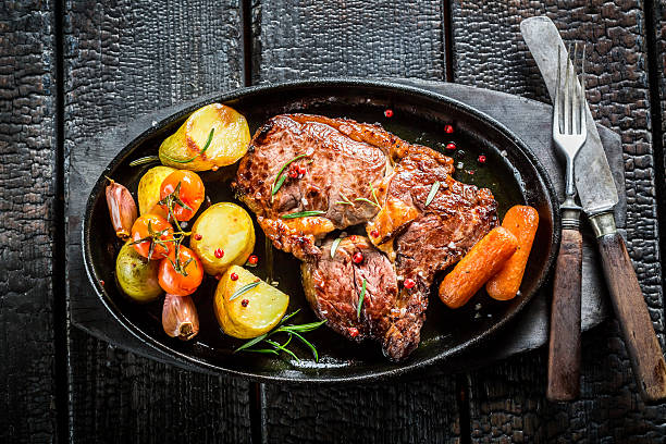 istock Roasted vegetables and steak with fresh herbs 545437084