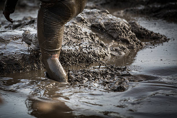 istock Deep muddy water with feet splashing and climbing 545439824