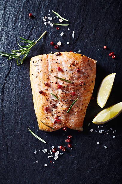 oven-roasted salmon fillet on a black slate - fish spice imagens e fotografias de stock