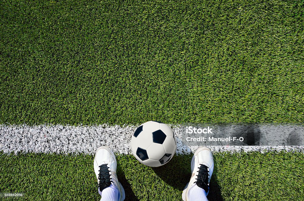 boot and ball soccer shot of a soccer player standing on the field with copy space Soccer Stock Photo