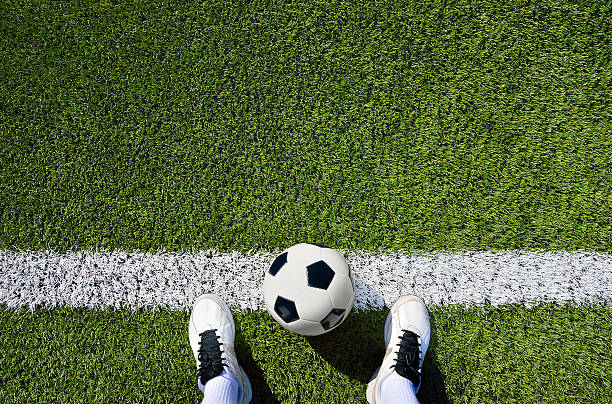boot and ball soccer shot of a soccer player standing on the field with copy space football pitch stock pictures, royalty-free photos & images