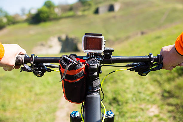 istock Hands in orange jacket holding handlebar of a bicycle 545445146