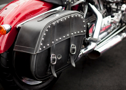 Vintage studded leather bag on a cool red motorcycle.