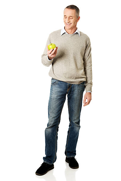 istock Full length mature man with an apple 545445644