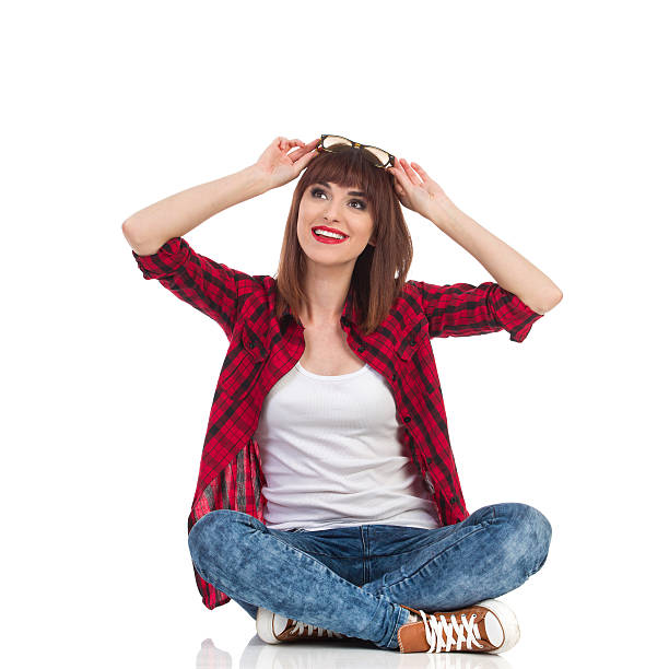 istock Curious Young Woman Sitting With Legs Crossed 545445806