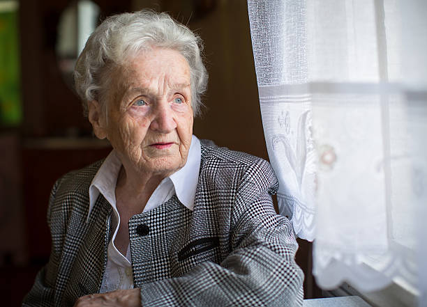 istock An elderly woman, sitting at the table, a portrait. 545446110