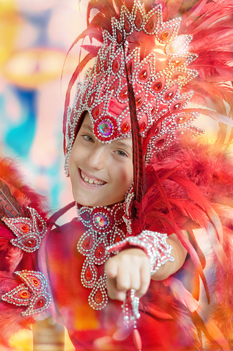 Cute little 8 years old girl in Carnival costume dancing Samba pointing at you
