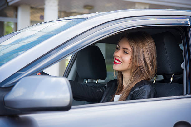 istock Pretty female driver riding a car 545447064