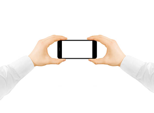 Man hold phone blank screen mockup in two hands, taking photo. Clear display smartphone mockup taking self shot, selfie photography.