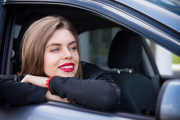 istock Pretty female driver riding a car 545447956