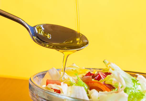 istock spoon with olive oil on italian fresh salad 545448874