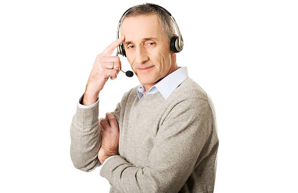 istock Call center man wearing a headset touching head 545449804