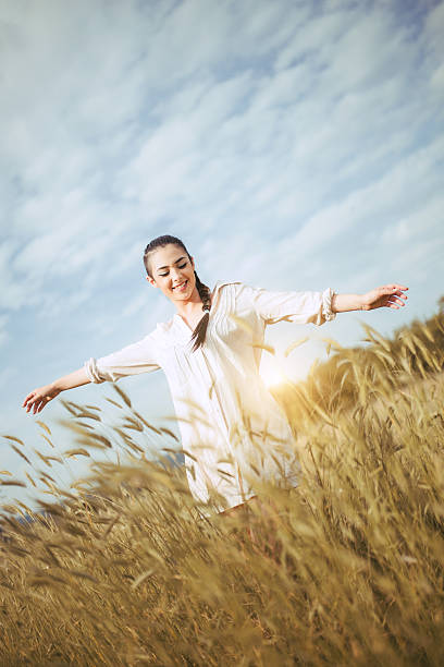 istock Pretty young woman in field at sunset 545450730