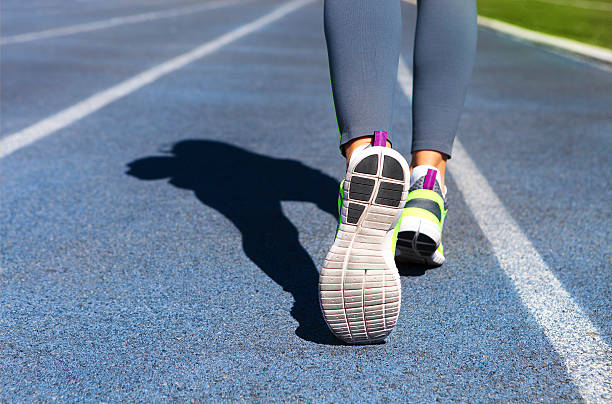 istock Athlete runner feet down stadium track. Jogging, sport, healthy 545452840