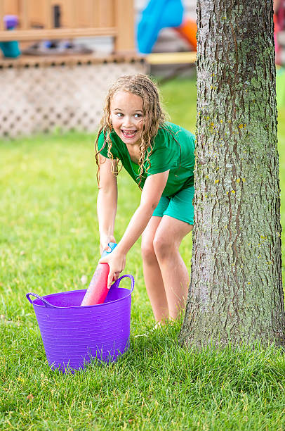 Two children of Japan playing in a plastic pool in the house of veranda