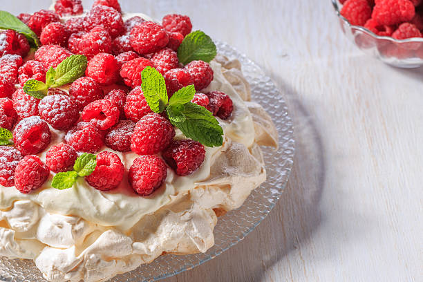 istock Meringue Pavlova  with whipped cream and fresh raspberries. 545454438