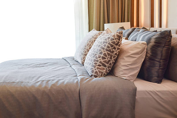 istock stylish bedroom interior design with brown pillows on bed 545455770