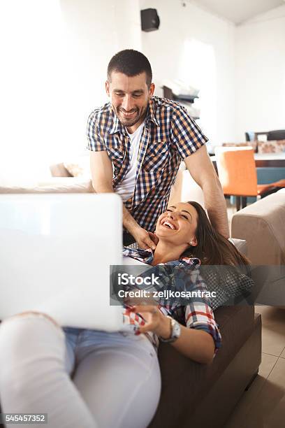 Young Couple Using Laptop Stock Photo - Download Image Now - Adult, Adults Only, Apartment