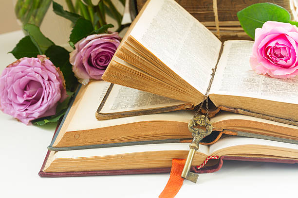 istock Old books with rose flower 545461618