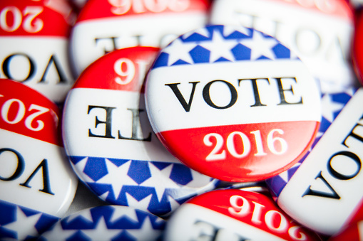 Close up of Vote election buttons, with red, white, blue and stars and stripes.