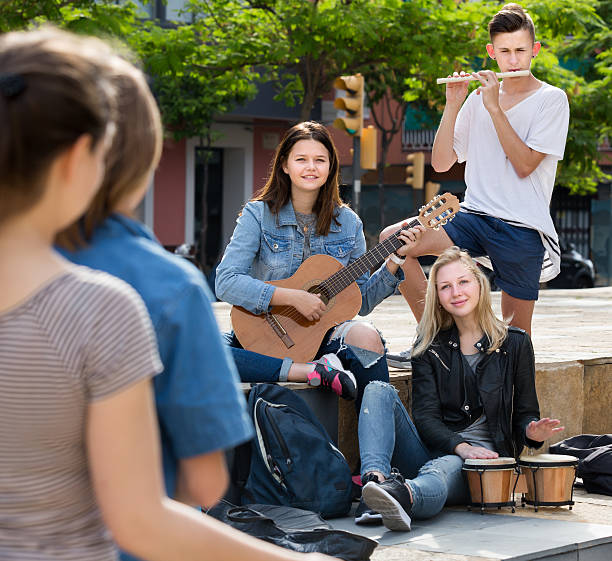 istock Cheerful four friends with musical instruments 545462482