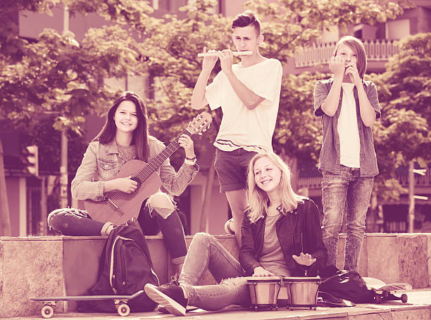 istock Cheerful girls and boys with musical instruments 545462550