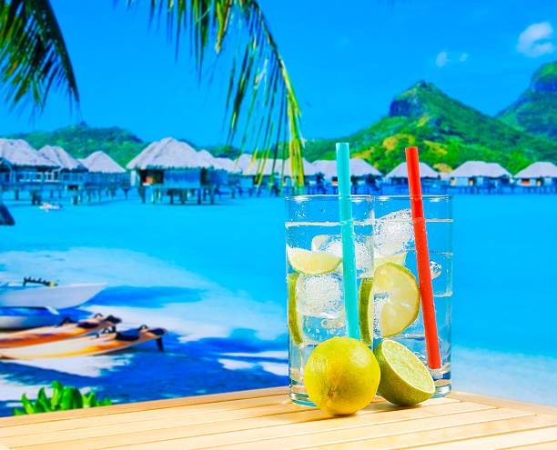 istock two glasses of cocktail with lime slice on blur beach 545463976