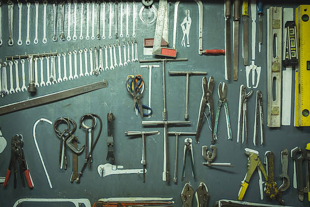 istock Old group of different hand tools hanging on the board. 545465034