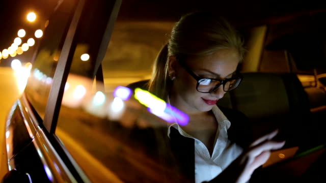 Girl driving at night in the taxi