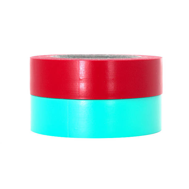 istock Protecting red, cyan insulating tape rolls isolated on white background 545549286