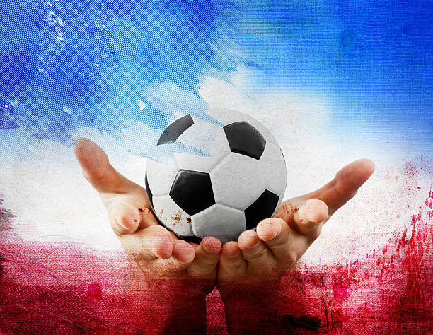 istock Hands holding football on France's flag colored background 545551068