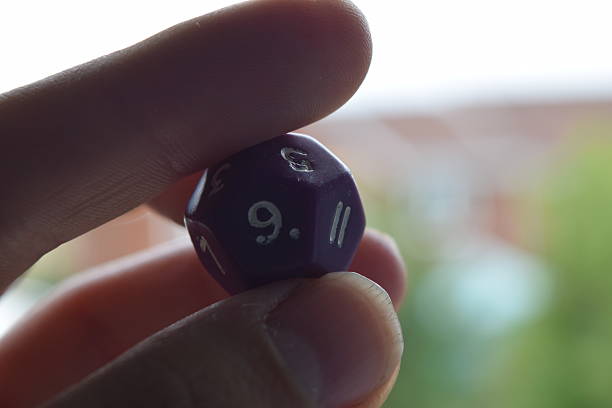 istock holding vitual 12 sided role playing game dice numbers background 545553608