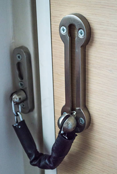istock Door Chain/Lock on a Wooden Door Full View 545554210